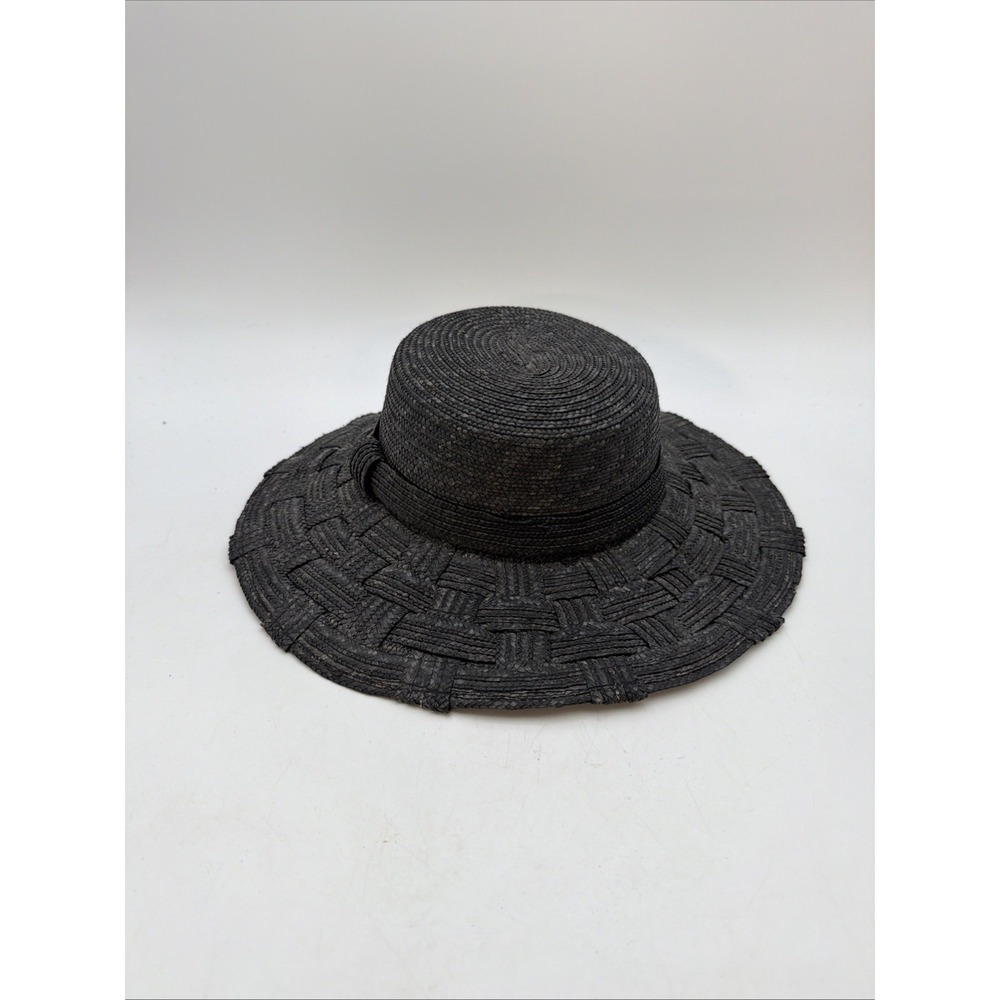 black woven straw hat with a flat crown and a wide, textured brim
